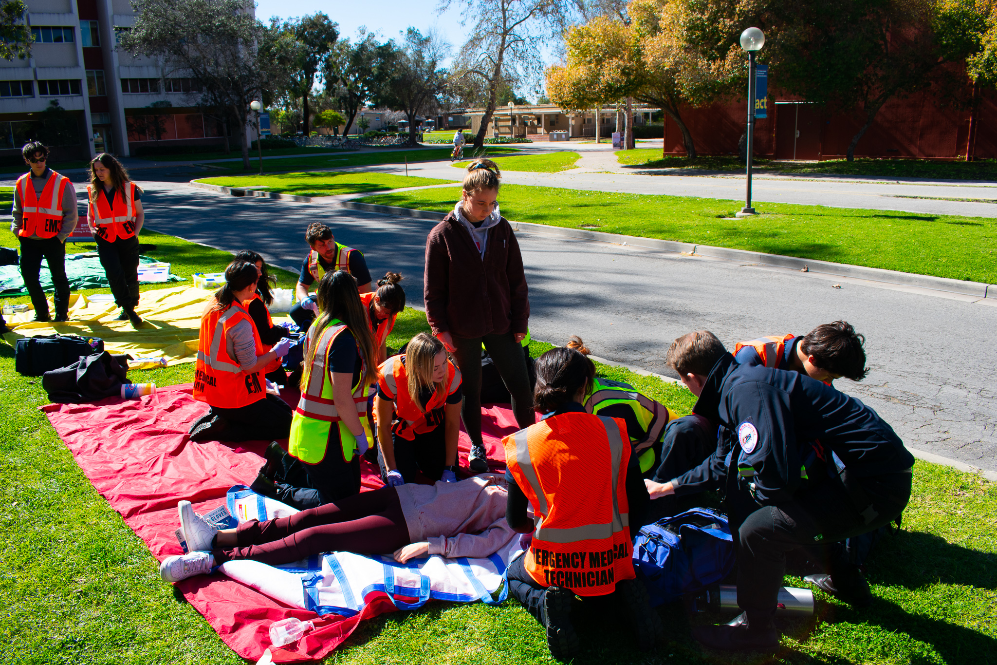 EMT Students working on the ground on "patients" laying on triage tarps
